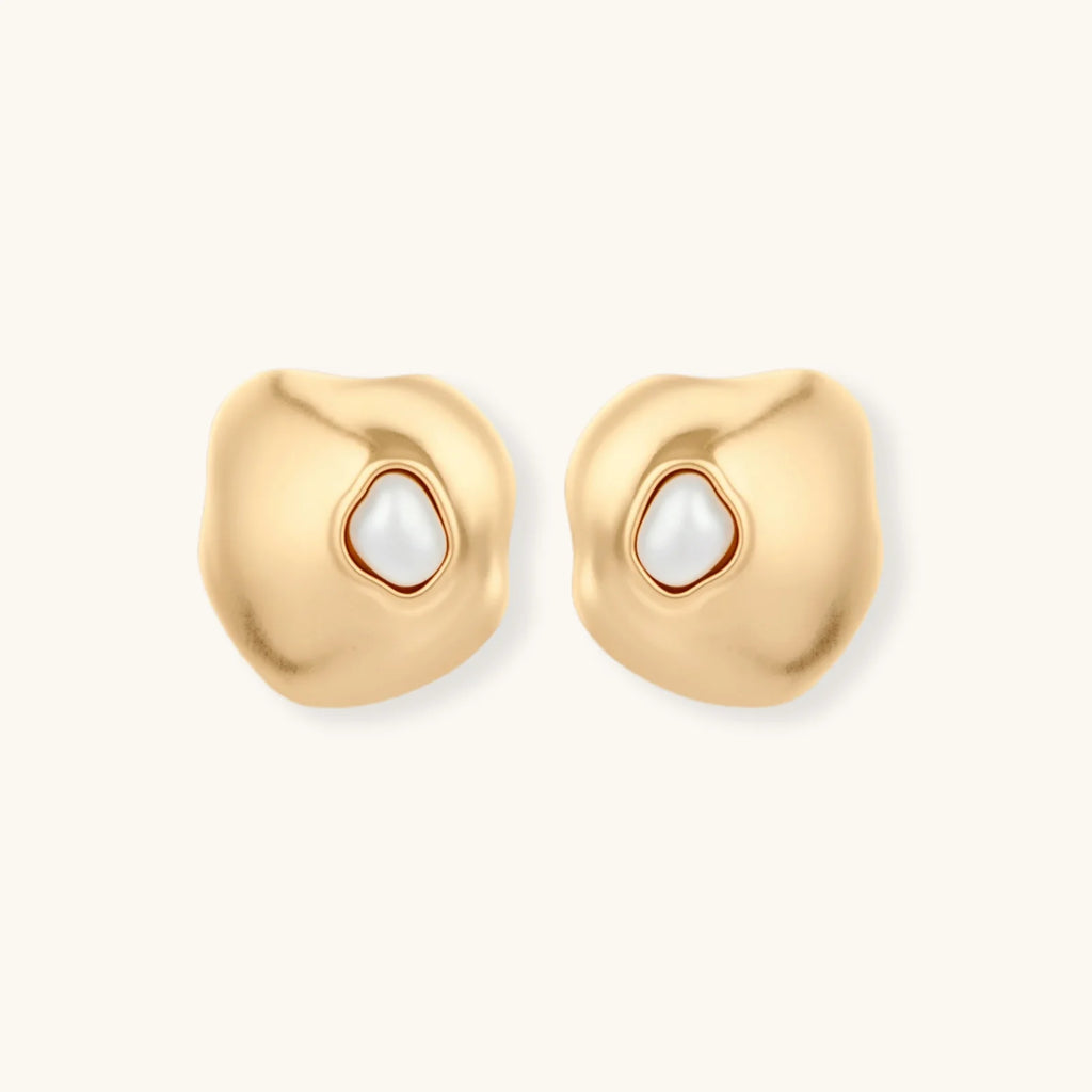 Organic-shaped eco-zinc alloy stud earrings with resin pearl centers and sterling silver posts on white background.