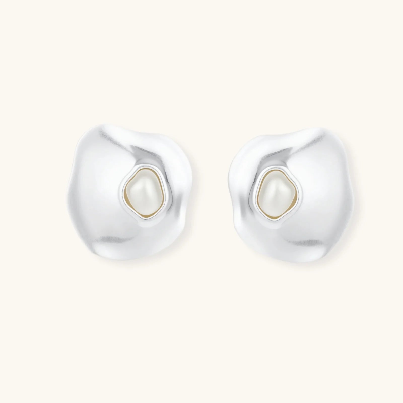 Organic-shaped eco-zinc alloy stud earrings with resin pearl centers and sterling silver posts on white background.