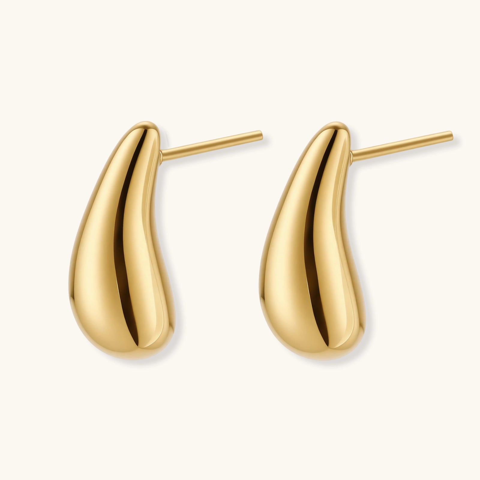 Pair of gold-plated sterling silver teardrop stud earrings with polished finish on white background.