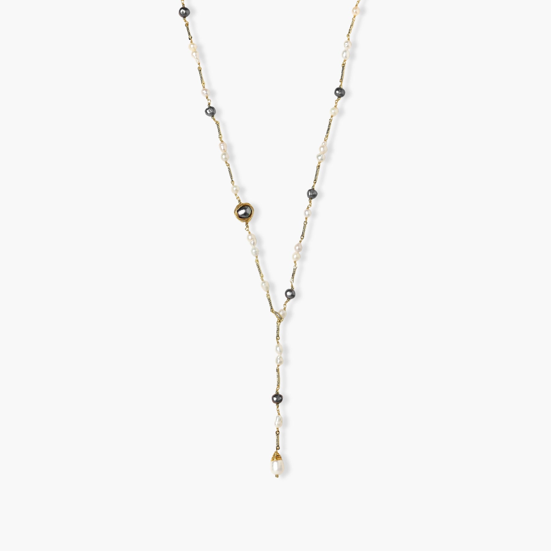 Y-shaped gold-plated necklace with white and gray freshwater pearls on cream background, showing adjustable drop design.